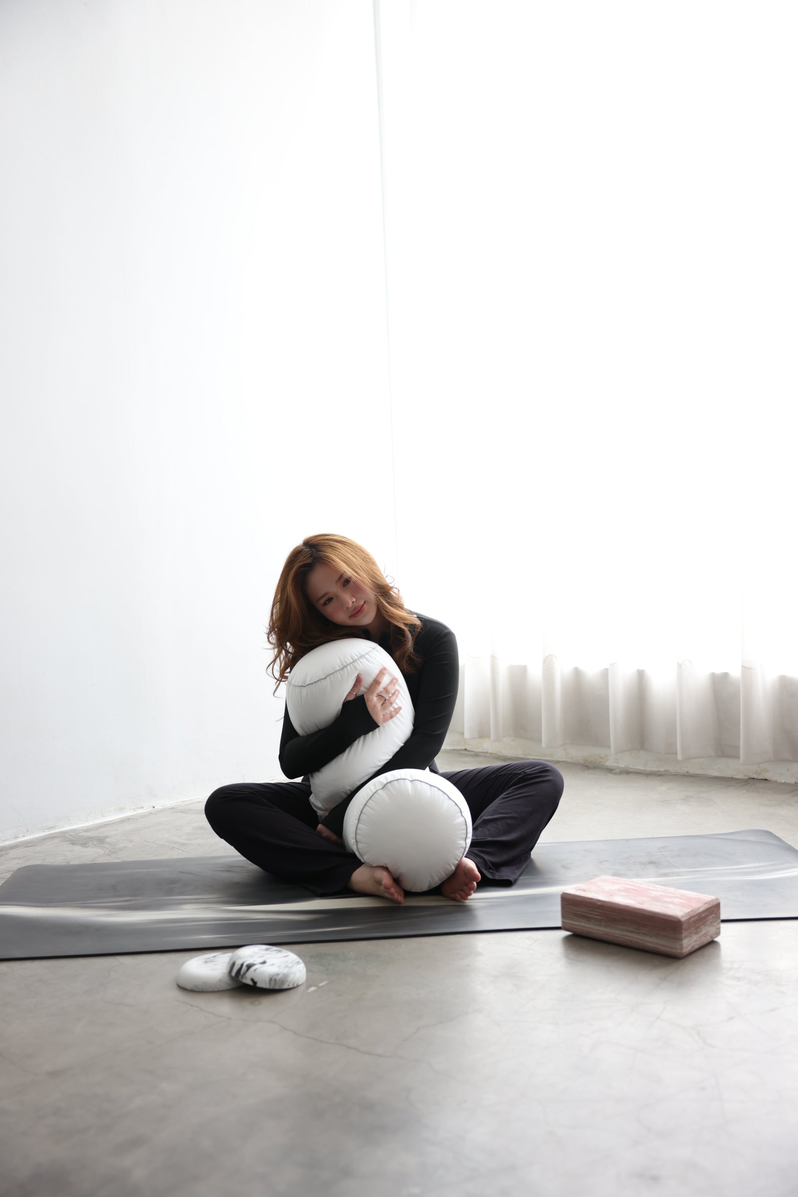 Woman standing with Koalu bolster